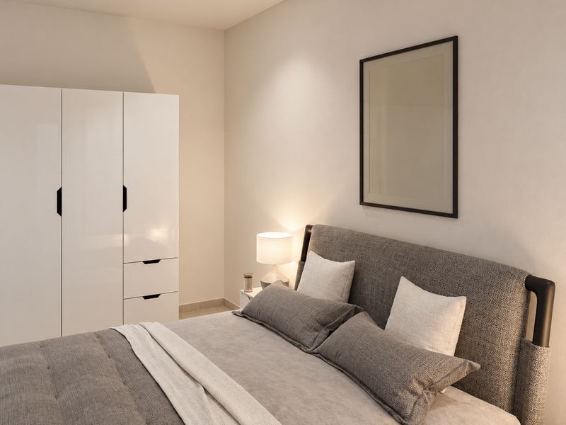 Quarto principal da fração F, com cama de casal e roupeiro branco