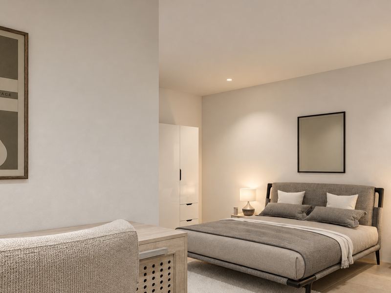 Quarto principal da fração F, com cama de casal e quadros