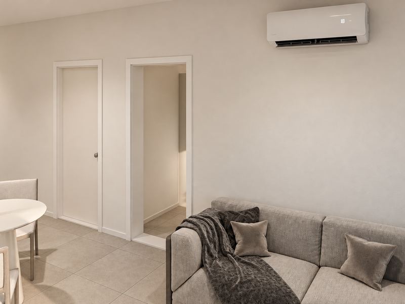 Sala da fração H, com sofá e acesso aos quartos