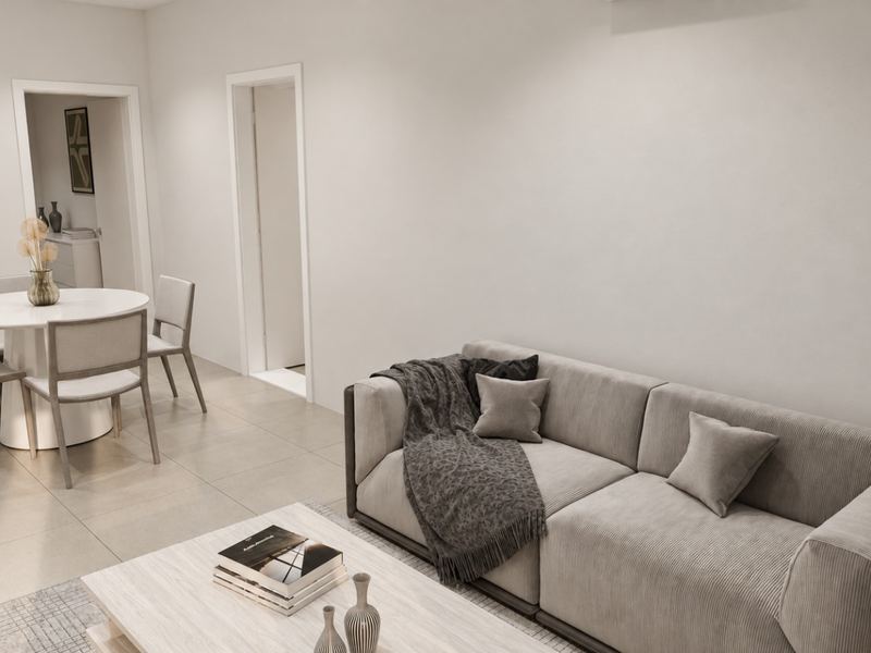 Sala da fração K, com sofá e mesa de refeições ao fundo