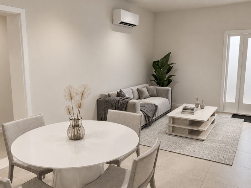 Sala da fração K, com mesa redonda, sofá e porta envidraçada